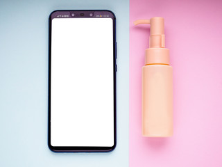 mobile phone with text layout and cosmetic tube, flat lay