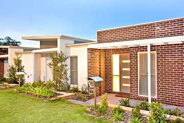 Luxury house front side with brick walls and lawn