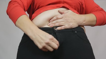 Fat lady makes an effort to fasten her pants, weight problems, diet