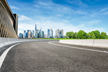 Asphalt road and modern city commercial building scenery in Shanghai