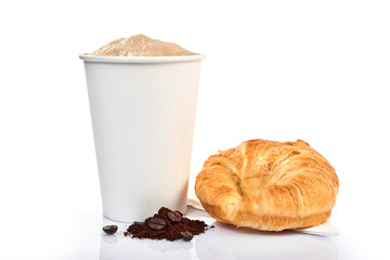 coffee cup and croissant isolated on a wooden table