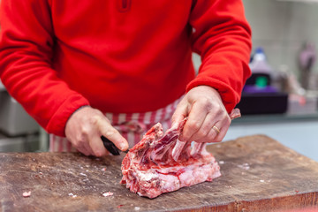 butcher cuts meat on the street market