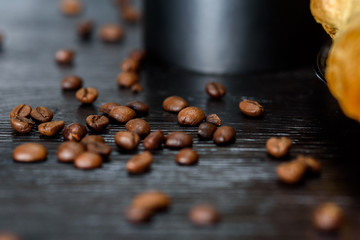 Coffee and chocolate eclairs on a wooden background