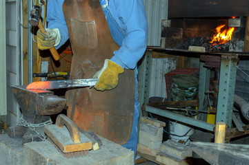 The bladesmith forges a knife in the blacksmith shop in Missouri.