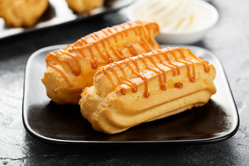 Traditional french eclairs with caramel sauce.