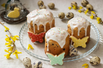 Easter composition of Easter cakes, biscuits, eggs and forsythia flowers. Rustic style.