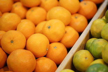 Close up view of orange fruits on the shelf in the supermarket.