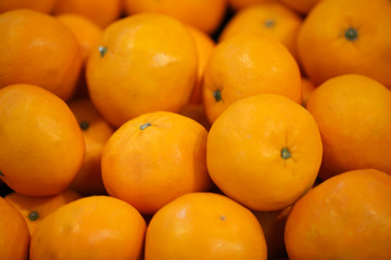Close up view of orange fruits on the shelf in the supermarket.