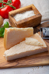 Original italian cheese, aged Parmesan cow milk cheese, pieces and grated Parmigiano-Reggiano