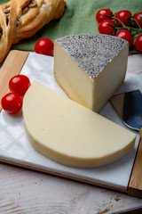 Italian cheeses, mature Tuscan Pecorino sheep cheese and Provolone dolce cow cheese served with olive bread and tomatoes