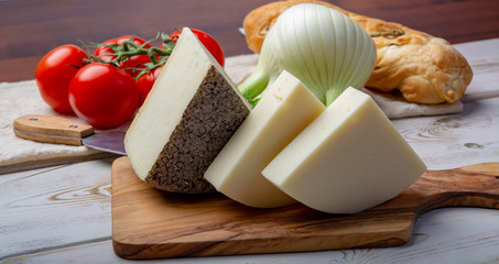 Italian cheeses, mature Tuscan Pecorino sheep cheese and Provolone dolce cow cheese served with olive bread and tomatoes