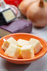 Mini black and dark red waxed cheddar cheeses with strong flavor made from West Country milk and and age-old methods with onion and garlic in England
