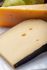 Pieces of aged original Dutch hard cheeses close up