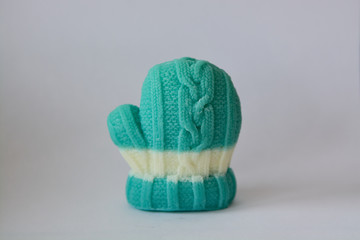 Soap gift in the form of winter mittens on a gray background.