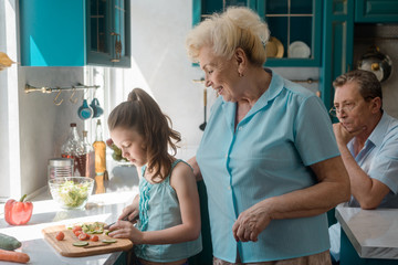 Granny teaches granddaughter to cook