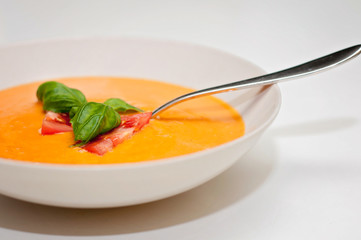 Vegan food and healthy vegetarian lifestyle. A tomato soup with nutritious ingredients like fresh basil is suitable for vegetarian plant based diet.