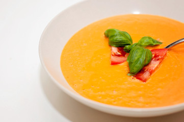 Vegan food and healthy vegetarian lifestyle. A tomato soup with nutritious ingredients like fresh basil is suitable for vegetarian plant based diet.