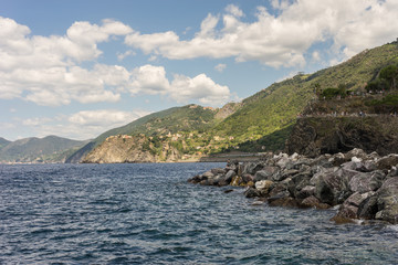 Fototapeta na wymiar Italy, Cinque Terre, Monterosso, a body of water with a mountain in the background