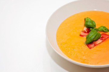 Vegan food and healthy vegetarian lifestyle. A tomato soup with nutritious ingredients like fresh basil is suitable for vegetarian plant based diet.