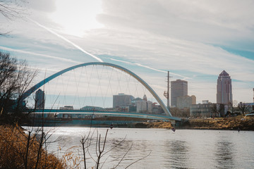 Downtown Des Moines and the Iowa Women of Achievement Bridge from the banks of the Des Moines River in Des Moines, Iowa