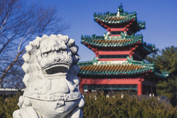 A Lion Statue Keeps Watch over an Asian-Style Building at Robert D. Ray Asian Gardens in Des Moines, Iowa