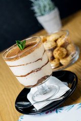 Italian dessert tiramisu in glass, sweet food