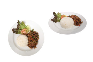 Fried rice with basil meat spicy food in a white plate isolated on background with clipping path. Speaking Thailand "pad ka prao".