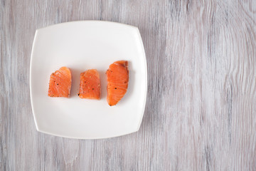 light-salted salmon on a light wooden background
