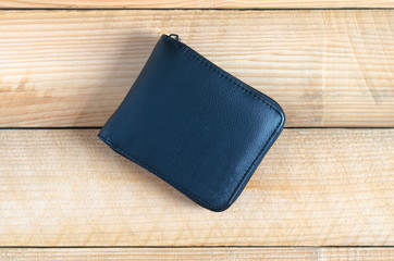 modern black leather wallet on wooden table background. wealth, saving, money, finance and investment concept.