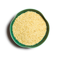 millet in bowl isolated on white background