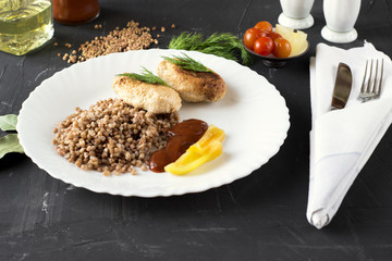 Chicken cutlets with buckwheat, herbs, ketchup and tomatoes