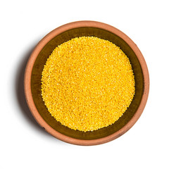 yellow millet in a bowl isolated on white background