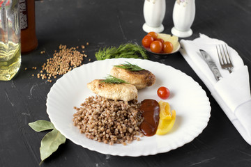 Chicken cutlets with buckwheat, herbs, ketchup and tomatoes