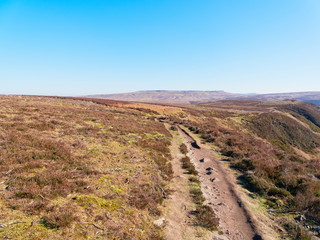 Fototapeta na wymiar A narrow footpath follows the edge of a steep hillside in the Derbyshire Peak Disrtict