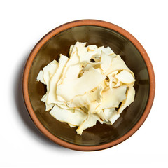 Ginseng slices on white background.