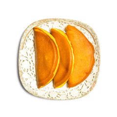 Overhead view of pumpkin pie on white background.