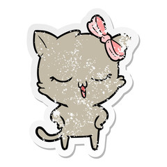 Obraz na płótnie Canvas distressed sticker of a cartoon cat with bow on head and hands on hips