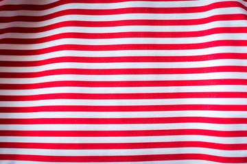 Striped red and white striped fabric, background.