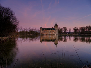 Fototapeta na wymiar Calm sunset and reflections Kasteel van Horst near Holsbeek, Vlaanderen, Belgium