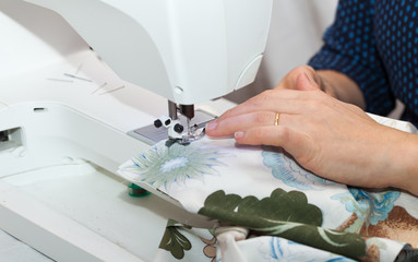 Seamstress hands at work, threads and needles