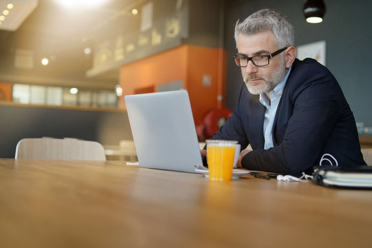 Businessman Working In Modern Office Cafeteria