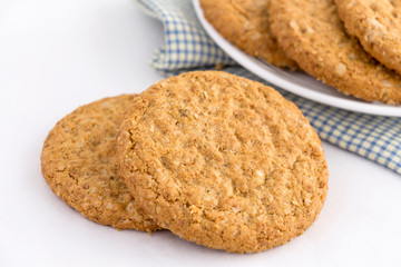 Homemade shortbread cookies made of oatmeal are pile on white plate on the cloth background. Concept food healthy snack for enjoy in holiday.