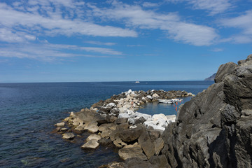 Fototapeta na wymiar Italy,Cinque Terre,Riomaggiore, a rocky island in the middle of a body of water