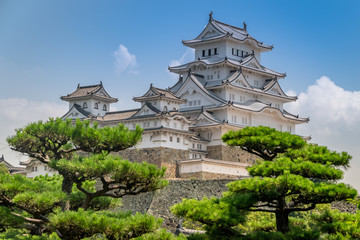 Fototapeta na wymiar Himeji Japanese hilltop castle. Regarded as the finest surviving example of Japanese castle architecture, with advanced defensive systems from the feudal period. Also known as the White Heron Castle.