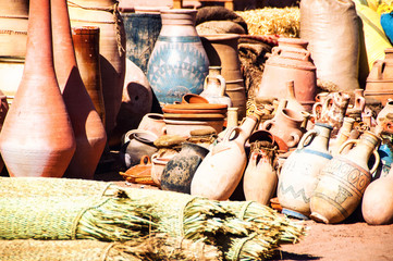 Fototapeta na wymiar Differently sized dusty Clay pots stuck together at the village market in Moroccan town Ouarzazate