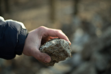 stone in man's hand