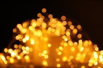 Gold glitter with bokeh effect on dark background