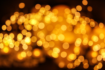 Obraz premium Gold glitter with bokeh effect on dark background