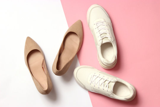  White Sneakers And High Heel Shoes On A Colored Background Top View. Women's Shoes. Classic And Sport Shoes.