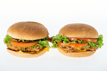 tasty unhealthy chicken burgers isolated on white